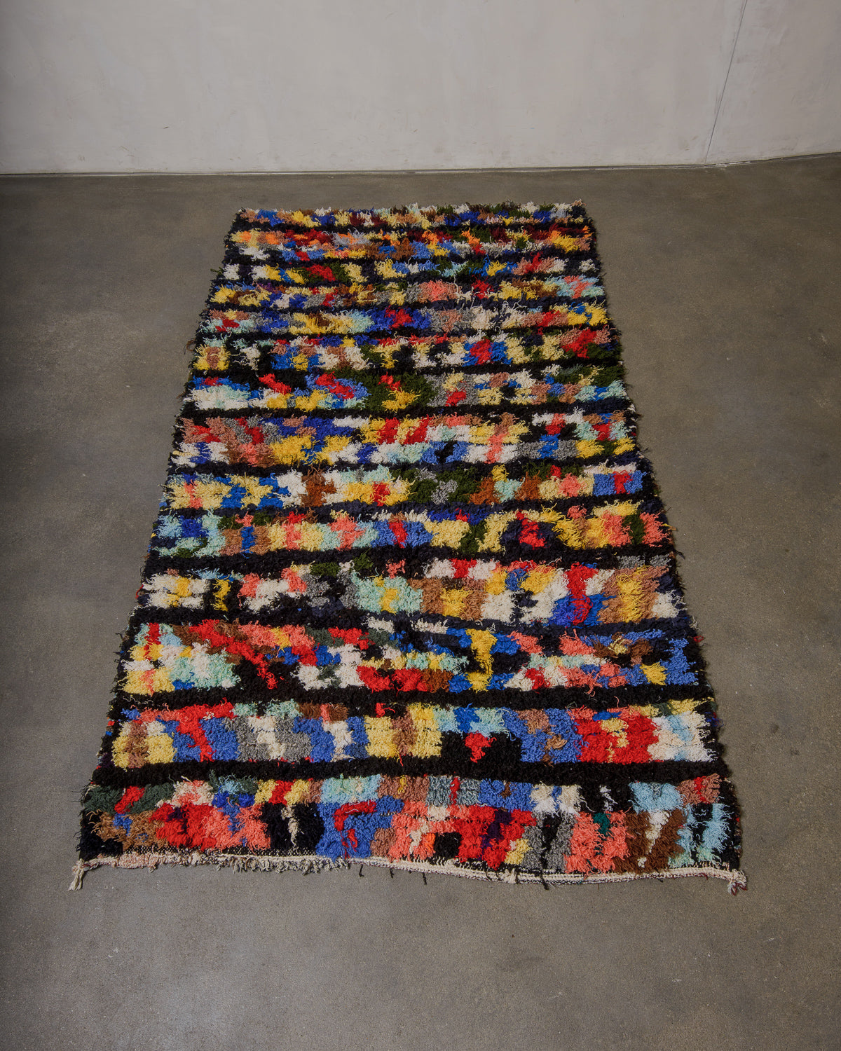 Multicolored geometric patterned rug on a plain floor